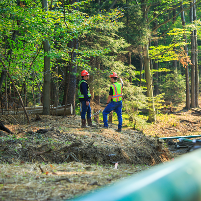 two men talking and pointing at a worksite